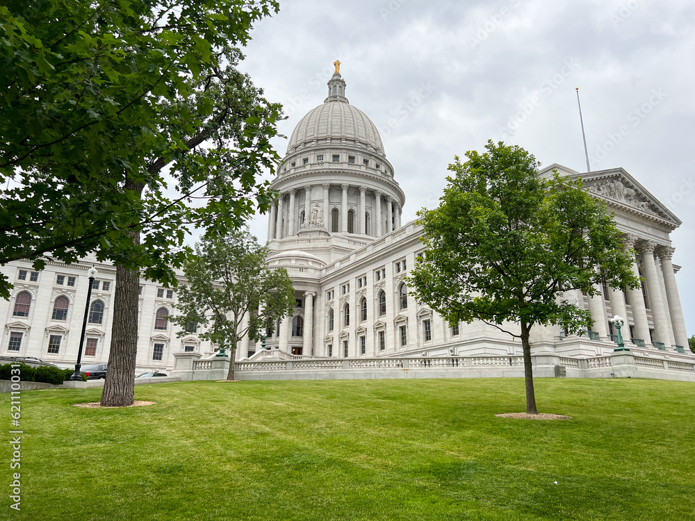 Madison Wisconsin State Capitol building with green grass and trees in the background
