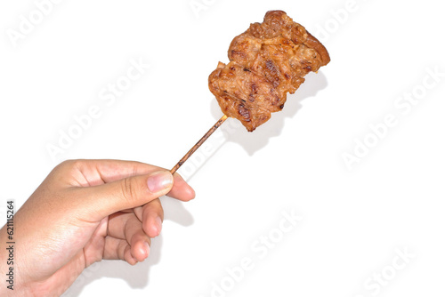 Hand holding grilled pork and bamboo stick with drop shadow , Thai Traditional Food
