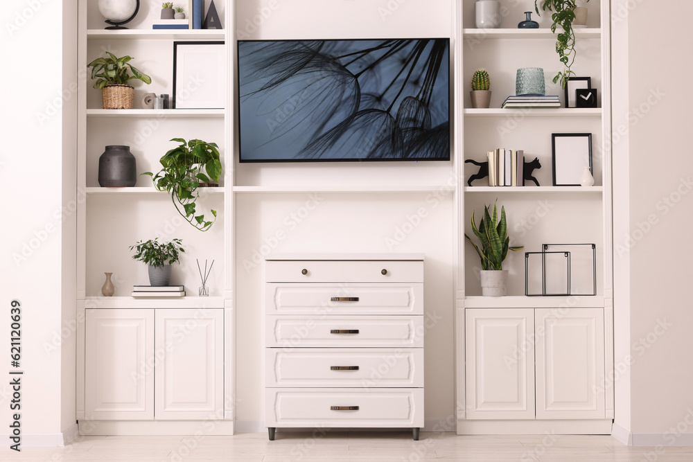 Interior design. Stylish tv area, chest of drawers and shelves with accessories Interior design. Stylish tv area, chest of drawers and shelves with accessories