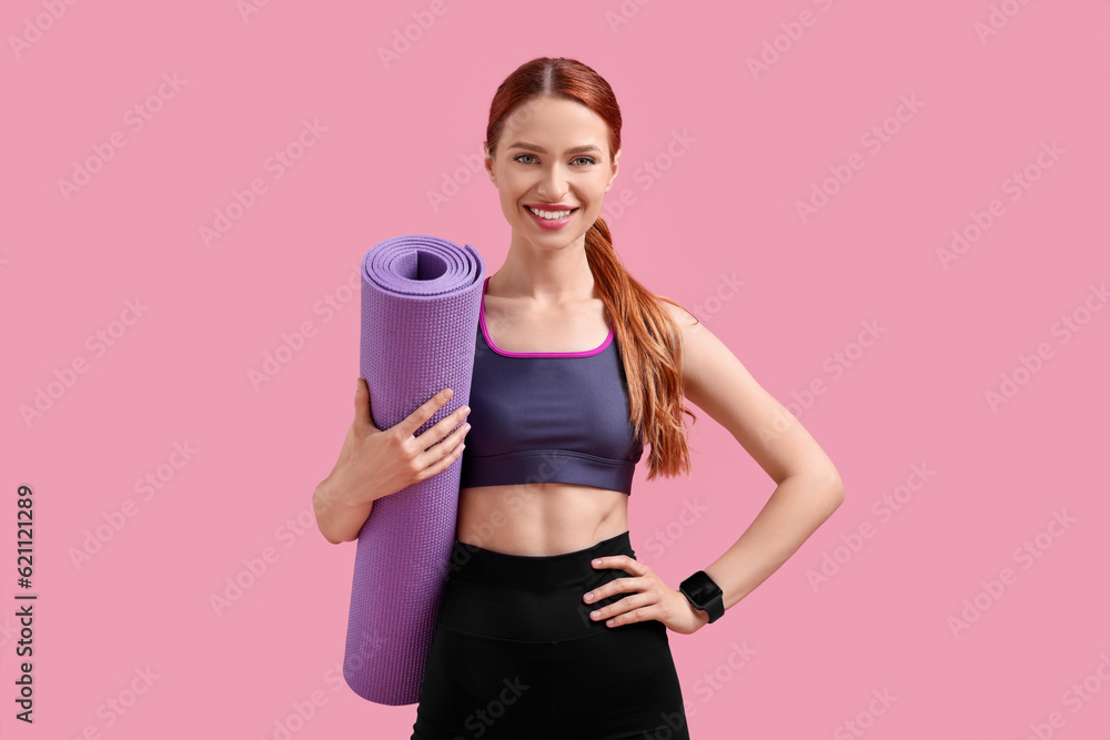 Woman in sportswear with fitness mat on pink background Woman in sportswear with fitness mat on pink background