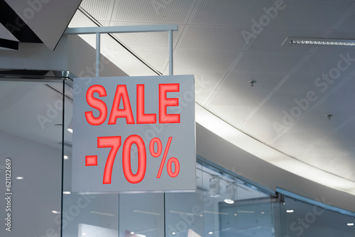 Sale sign near entrance in fashion store