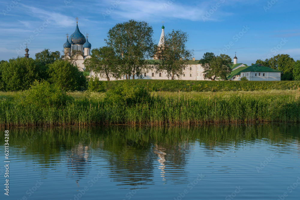Holy Intercession (Pokrovsky) Convent with the Cathedral of the Intercession of the Most Holy Theotokos on the bank of the Kamenka river on a sunny summer day, Suzdal, Vladimir region, Russia