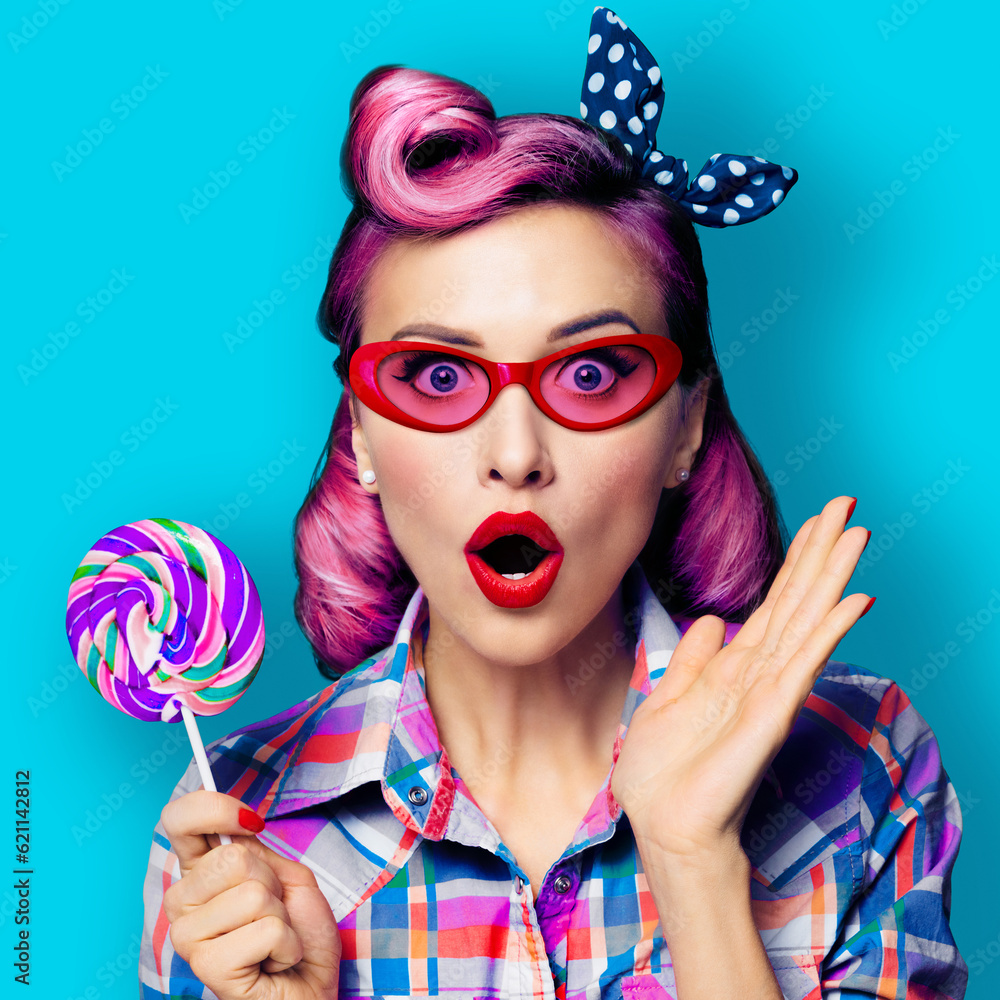 Purple head excited very surprised woman in red glasses with lollipop. Pinup girl with wide opened mouth, eyes. Retro fashion and vintage concept. Aqua blue color background square composition.