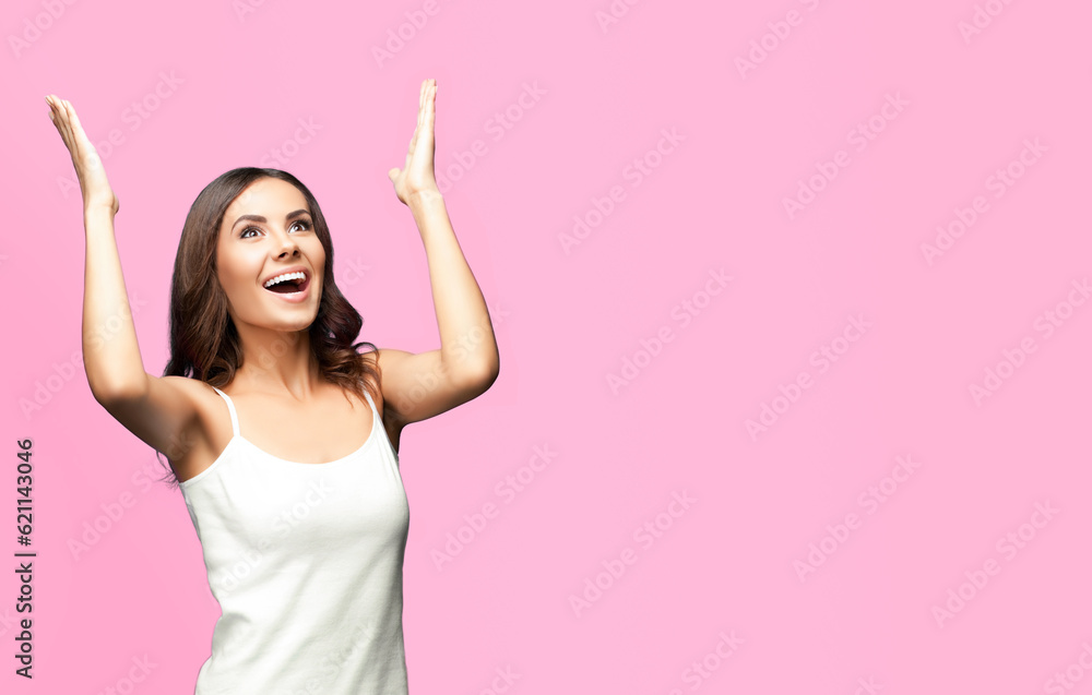Portrait studio image of happy gesturing or praying young beautiful woman looking up, in white casual clothing, isolated over rose pink color background. Copy space area for some text or slogan. Portrait studio image of happy gesturing or praying young beautiful woman looking up, in white casual clothing, isolated over rose pink color background. Copy space area for some text or slogan.