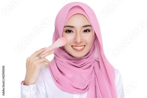 Close up young beautiful muslim woman with hijab applying makeup with brusher of cheek daily routine isolated on white background studio shot, Commercial Beauty muslim skin care and cosmetic concept. photo