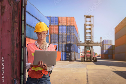 Female worker inspecting a logistic cargo container.
