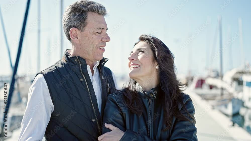 Senior man and woman couple hugging each other and kissing at port Senior man and woman couple hugging each other and kissing at port