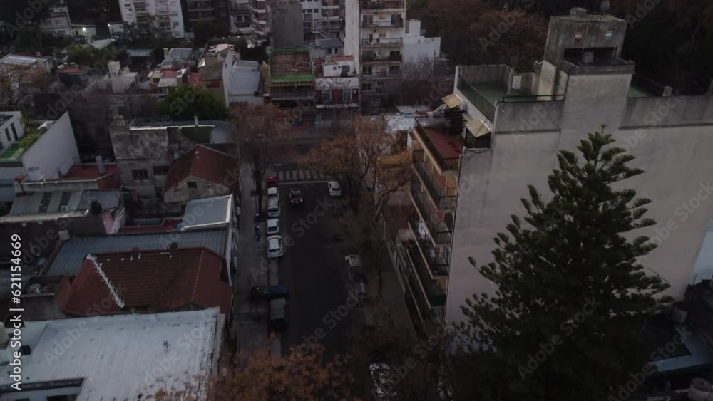 A drone flies over an old neighborhood in Buenos Aires, cars drive through the streets A drone flies over an old neighborhood in Buenos Aires, cars drive through the streets