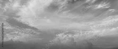 Grey sky with white clouds in rainy season, beautiful grey and white sky background textures, black and white sky, cloudy sky with stormy clouds. Low cumulus clouds of various shapes cover almost the 