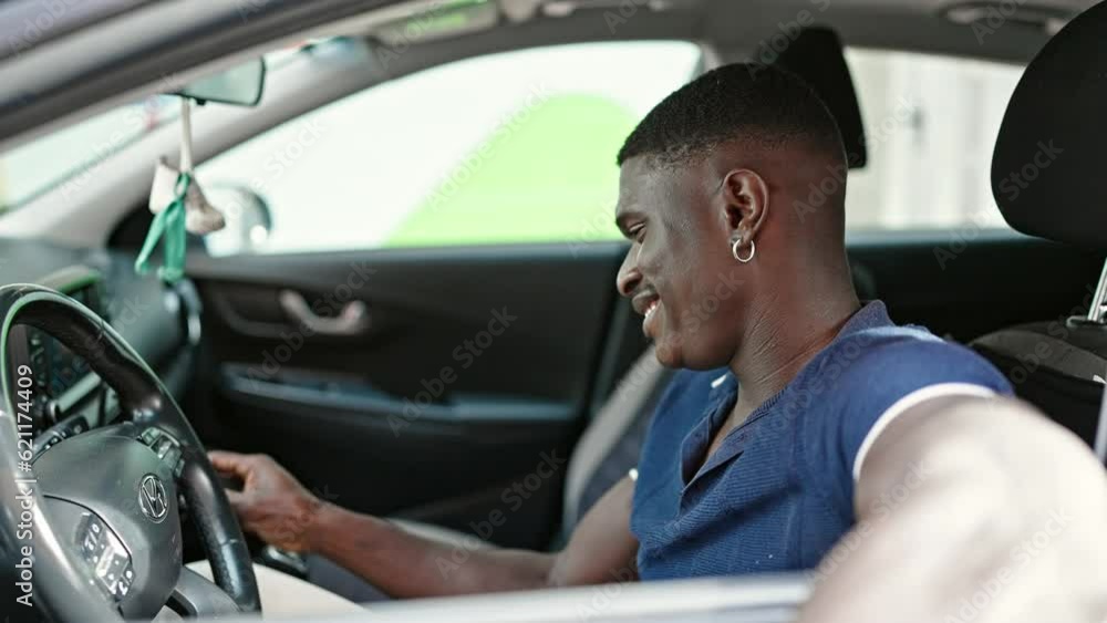 African american man holding key starting car at street African american man holding key starting car at street