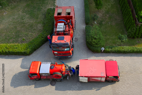 Aerial view, truck vehicles to pipe unclogging and bailer in floods , professional service company.