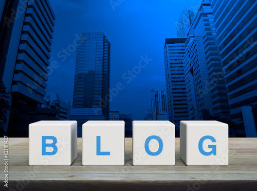 BLOG letter on white block cubes on wooden table over modern office city tower and skyscraper, Business communication concept