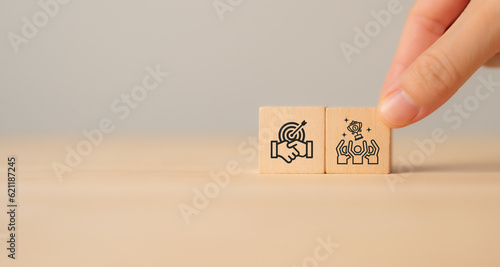Business success and leadership concept. Teamwork running to goal and achieving successful business. Common goals, growth performance, market leader icon on wooden cube blocks with grey background.