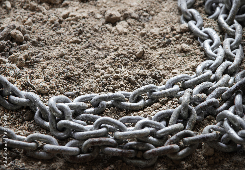 An old metal chain lies on the ground An old metal chain lies on the ground