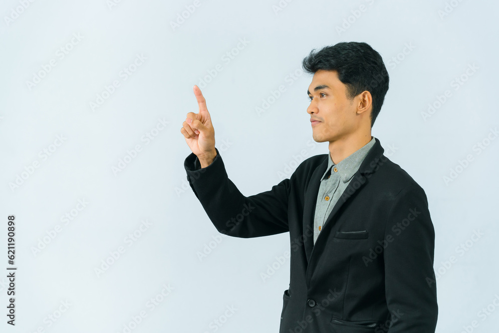 Handsome and friendly smiling asian businessman in formal black suit standing pointing finger on white background Handsome and friendly smiling asian businessman in formal black suit standing pointing finger on white background