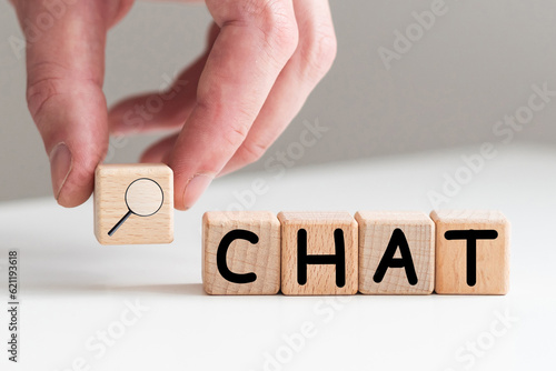 In the man's hand are cubes with the inscription - CHAT.