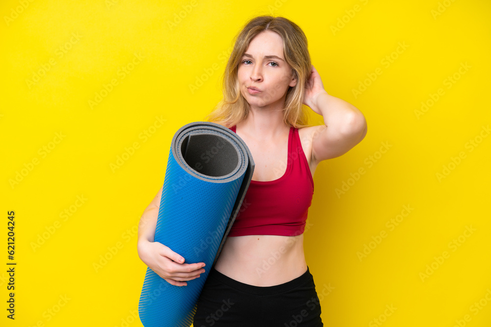 Young sport caucasian woman going to yoga classes while holding a mat isolated on yellow background having doubts Young sport caucasian woman going to yoga classes while holding a mat isolated on yellow background having doubts