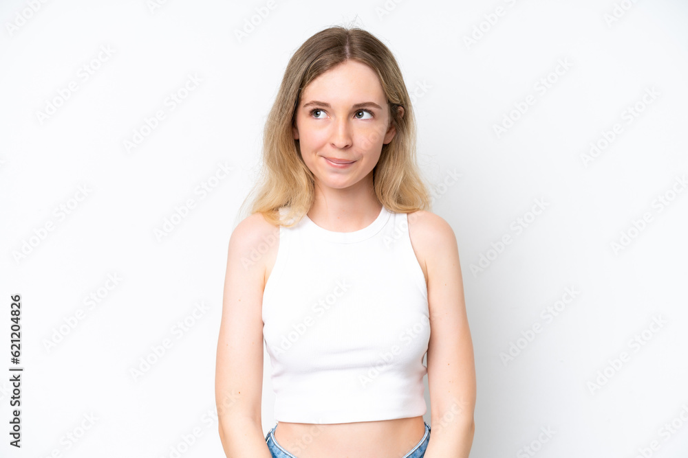 Blonde English young girl isolated on white background having doubts while looking up