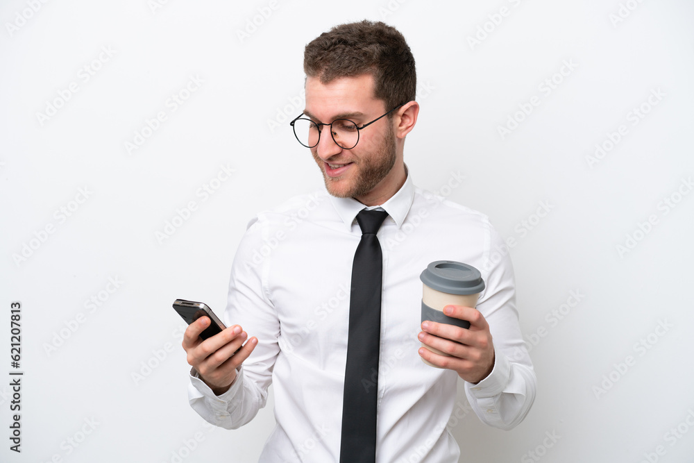 Young business caucasian man isolated on white background holding coffee to take away and a mobile Young business caucasian man isolated on white background holding coffee to take away and a mobile
