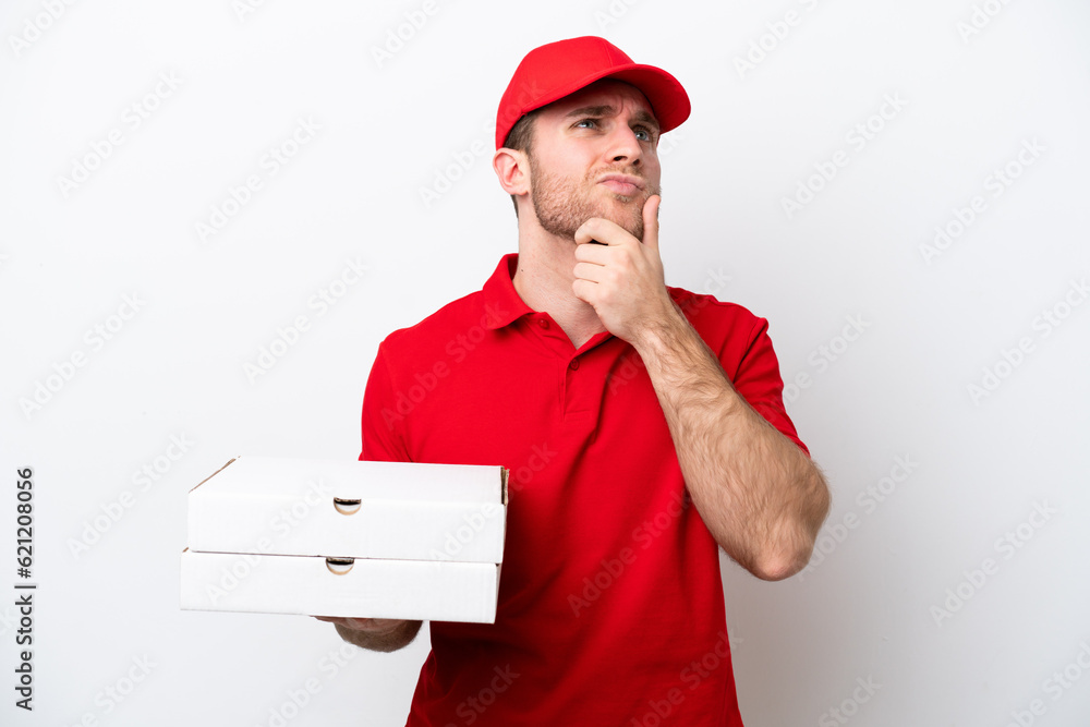 Pizza delivery caucasian man with work uniform picking up pizza boxes isolated on white background having doubts Pizza delivery caucasian man with work uniform picking up pizza boxes isolated on white background having doubts