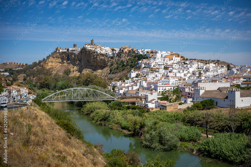 Panoramic view of the southern part of Arcos de la Frontera, Cadiz, Andalusia, Spain, with the churches on top, and a new bridge over the river