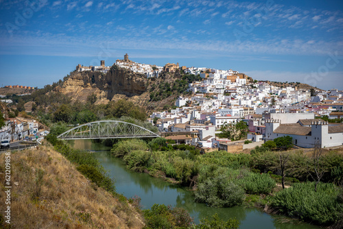 Panoramic view of the southern part of Arcos de la Frontera, Cadiz, Andalusia, Spain, with the churches on top, and a new bridge over the river photo
