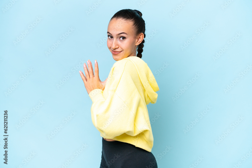 Young Arab woman isolated on blue background scheming something Young Arab woman isolated on blue background scheming something