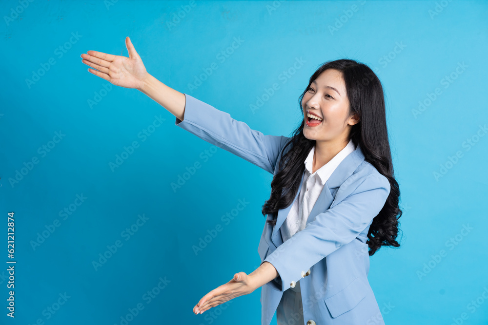 portrait of asian business woman posing on blue background portrait of asian business woman posing on blue background