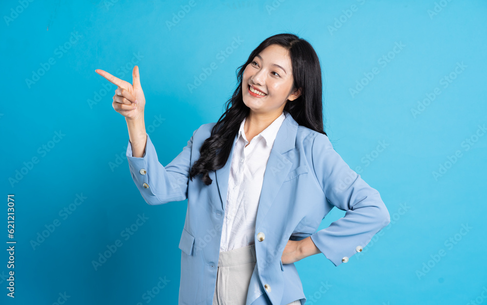portrait of asian business woman posing on blue background portrait of asian business woman posing on blue background