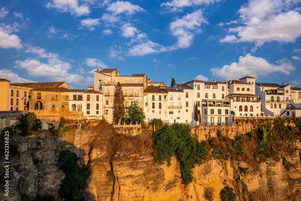 View of the old part of Ronda, Malaga, Spain, with the houses on the edge of a high-rise rock in evening light