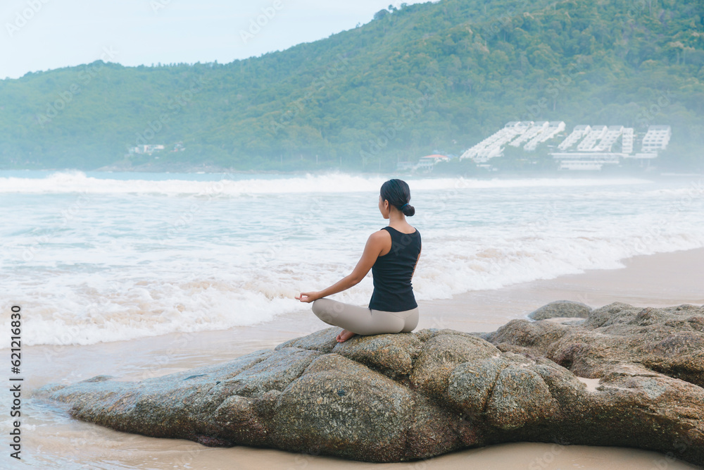 With each pose, a woman nurtures her body and soul during beach yoga, embracing the healing energy of the coastal environment. With each pose, a woman nurtures her body and soul during beach yoga, embracing the healing energy of the coastal environment.