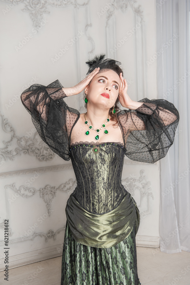 Φωτογραφία Sad emotional woman wearing green medieval vintage Victorian Style dress