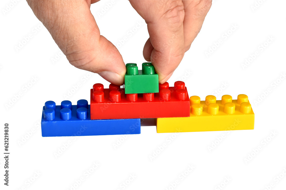 Φωτογραφία The man's hand folds the details of the children's designer.