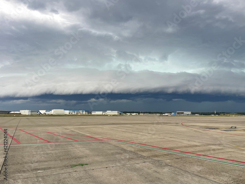 Shot of an arcus storm cloud gust front moving over the buildings of an airport