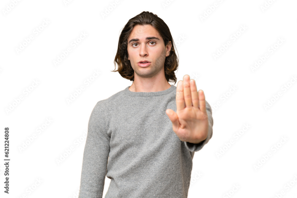Young caucasian man isolated on green chroma background making stop gesture Young caucasian man isolated on green chroma background making stop gesture