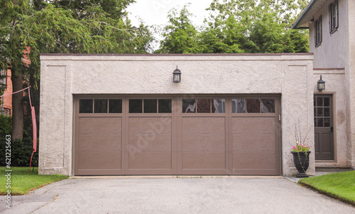 garage door stands as a gateway of privacy and utility, symbolizing security, shelter, and the hidden narratives within a home