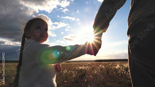child mother father hand sunset sky, hand mom dad kid girl, happy family childhood dream, teamwork, mother father field hold hand child sunset, family love concept, daughter mom walk sunset sky park