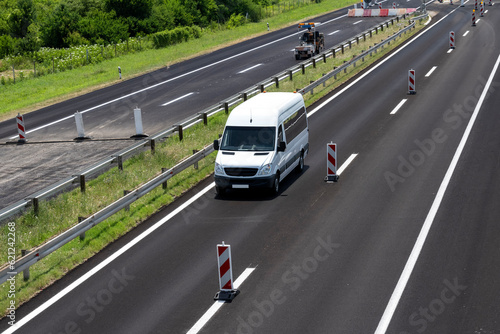 White Small modern comfortable tourist bus driving on the highway. The concept of travel and bus tourism. © Bojan