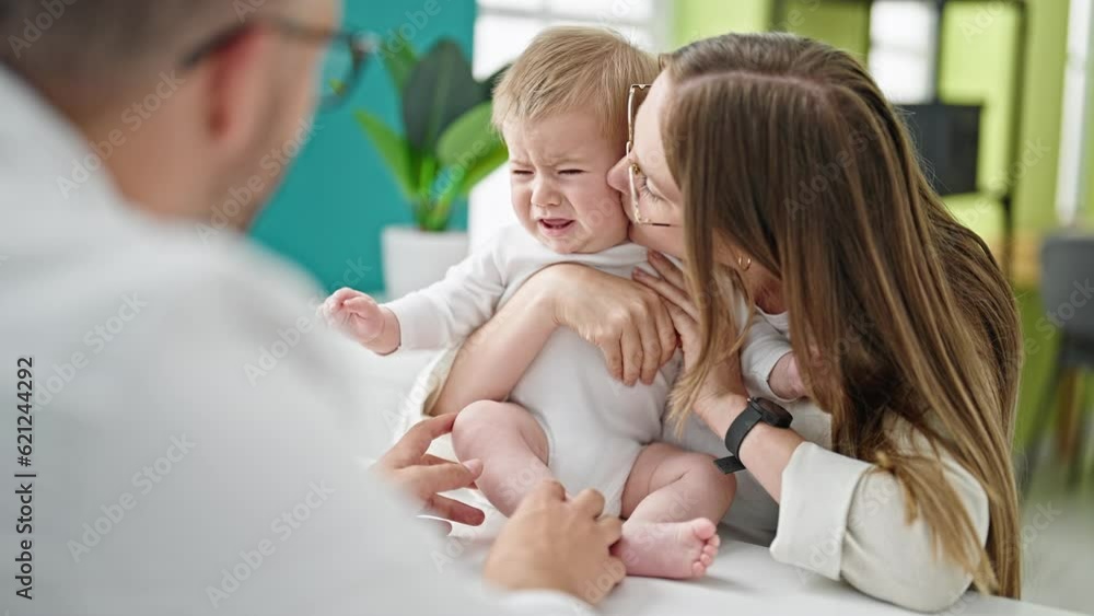 Caucasian mother with baby on a doctor appointment at clinic Caucasian mother with baby on a doctor appointment at clinic