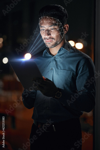 Asian man, tablet and facial recognition at night in biometrics for access, verification or identification at office. Businessman working late with technology and scanning face for cyber security photo