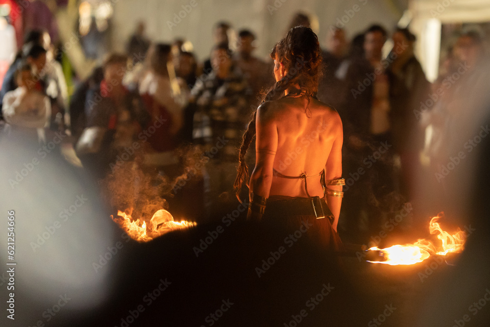 A woman performing a fire show at the street A woman performing a fire show at the street