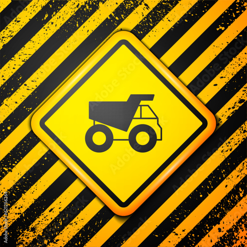 Black Mining dump truck icon isolated on yellow background. Warning sign. Vector