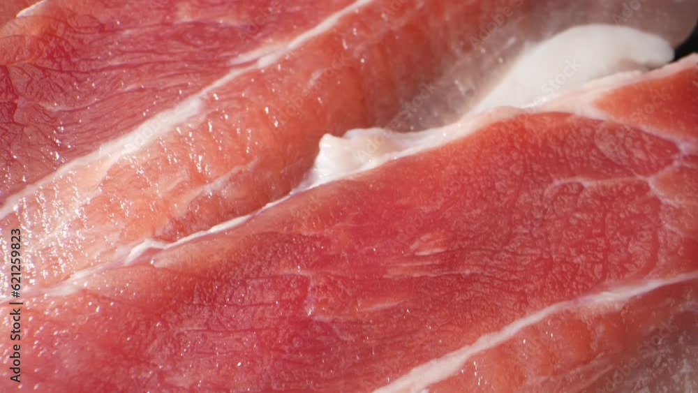 Macro video showcases succulent, raw pork belly slices in exquisite detail. Every tantalizing texture and marbled layer is magnified, inviting a feast for the eyes and igniting a carnivorous craving.
Macro video showcases succulent, raw pork belly slices in exquisite detail. Every tantalizing texture and marbled layer is magnified, inviting a feast for the eyes and igniting a carnivorous craving.