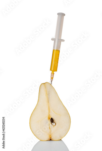 A pear with a syringe filled with chemicals