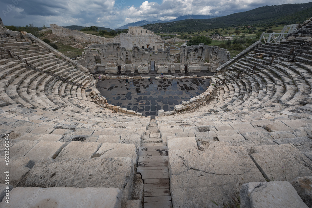 Roman theater at archaeological site of ancient city Patara in Lycia under cloudy sky, Turkey