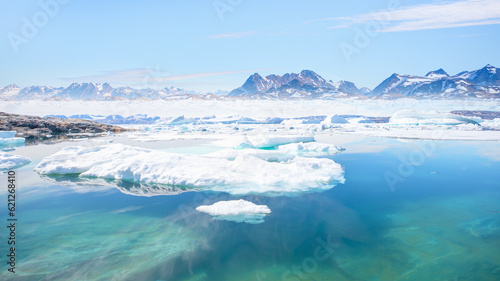 Melting icebergs by the coast of Greenland, on a beautiful summer day - Melting of a iceberg and pouring water into the sea - Greenland © muratart