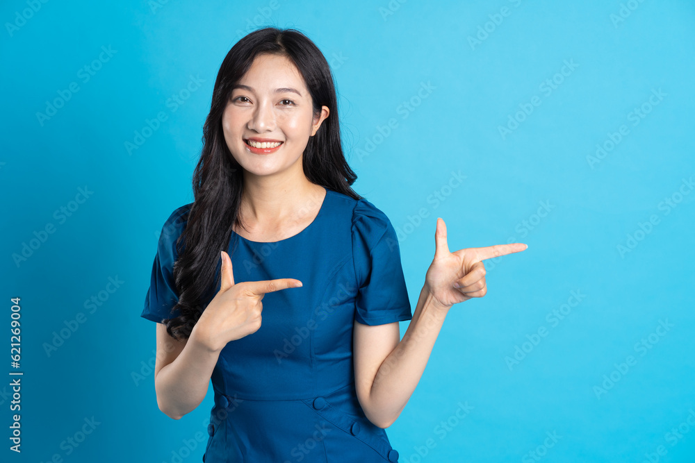 Portrait of beautiful woman in blue dress, isolated on blue background. Portrait of beautiful woman in blue dress, isolated on blue background.