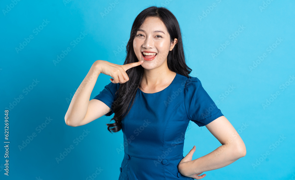 Portrait of beautiful woman in blue dress, isolated on blue background. Portrait of beautiful woman in blue dress, isolated on blue background.
