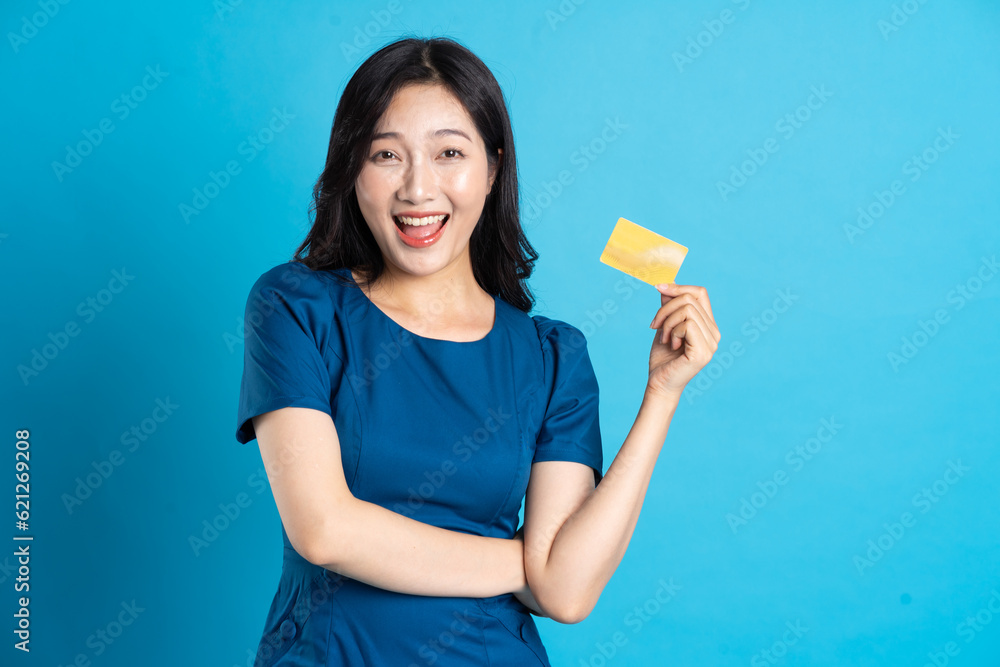 Portrait of beautiful woman in blue dress, isolated on blue background. Portrait of beautiful woman in blue dress, isolated on blue background.
