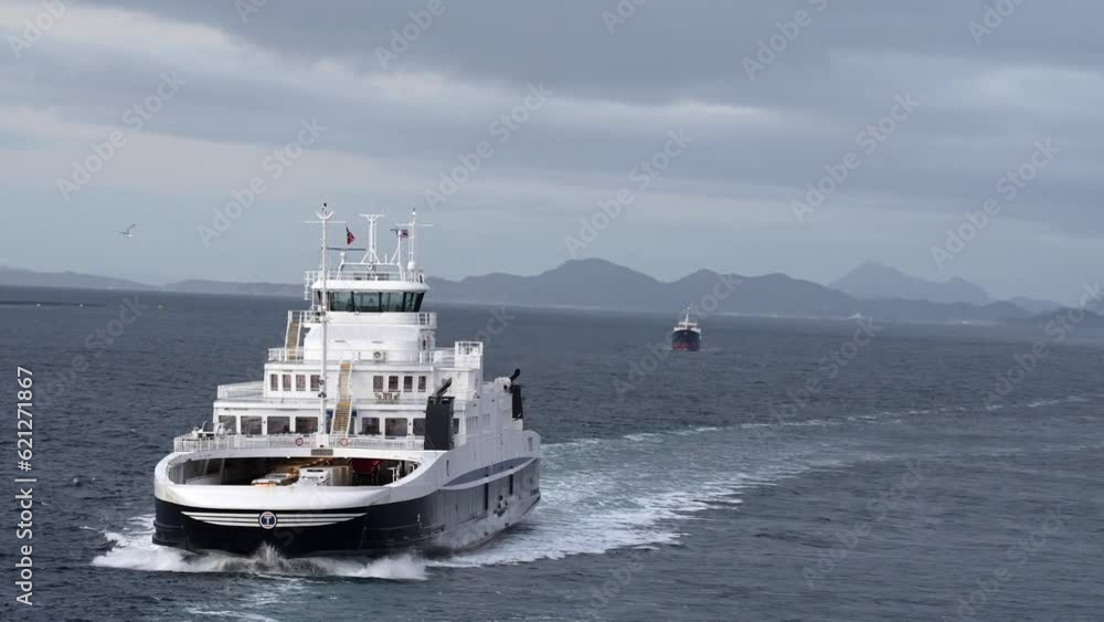 Norway. Amazing Summer Scenic View . Ship Or Ferry Boat Liner Floating In Famous Norwegian Natural Landmark And Popular Destination In Summer Day. snowy Lyngen Alps in background Norway. Amazing Summer Scenic View . Ship Or Ferry Boat Liner Floating In Famous Norwegian Natural Landmark And Popular Destination In Summer Day. snowy Lyngen Alps in background